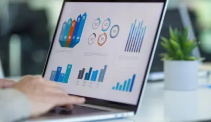 Image of a laptop with different graphs to show improvement