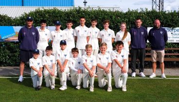 Staithes under 15 cricket team lined up on the pitch in two rows, with the front row knelt down.