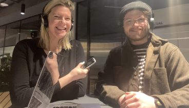 Talking Newspaper volunteers Katy Cowen and Hal Coleman, wearing headphones and holding an audio recorder.