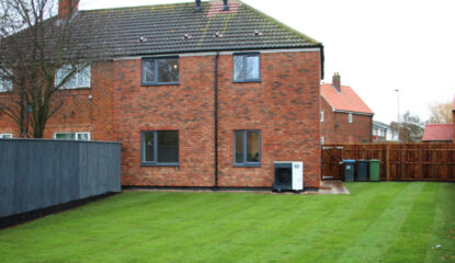 Image of the back of a new house and the garden